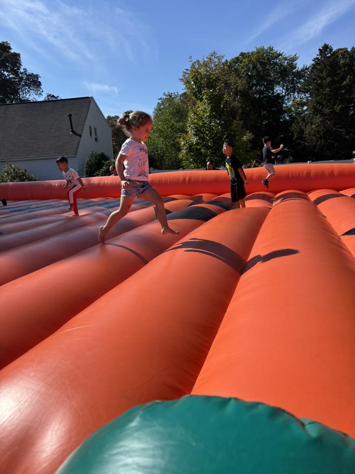 Children play on an inflatable bounce area at Wilmington Fall Fest.